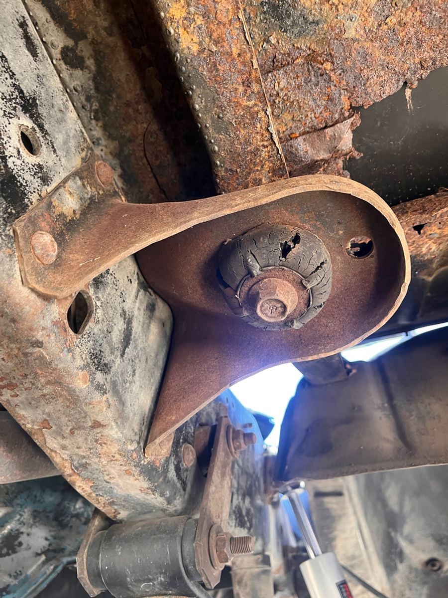 Heavy rust on a rear leaf-spring hanger and frame bracket