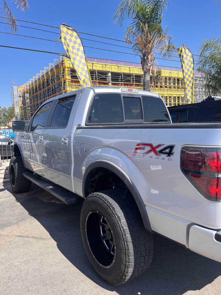 Silver Ford F-150 FX4 pickup photographed side-on in a parking lot