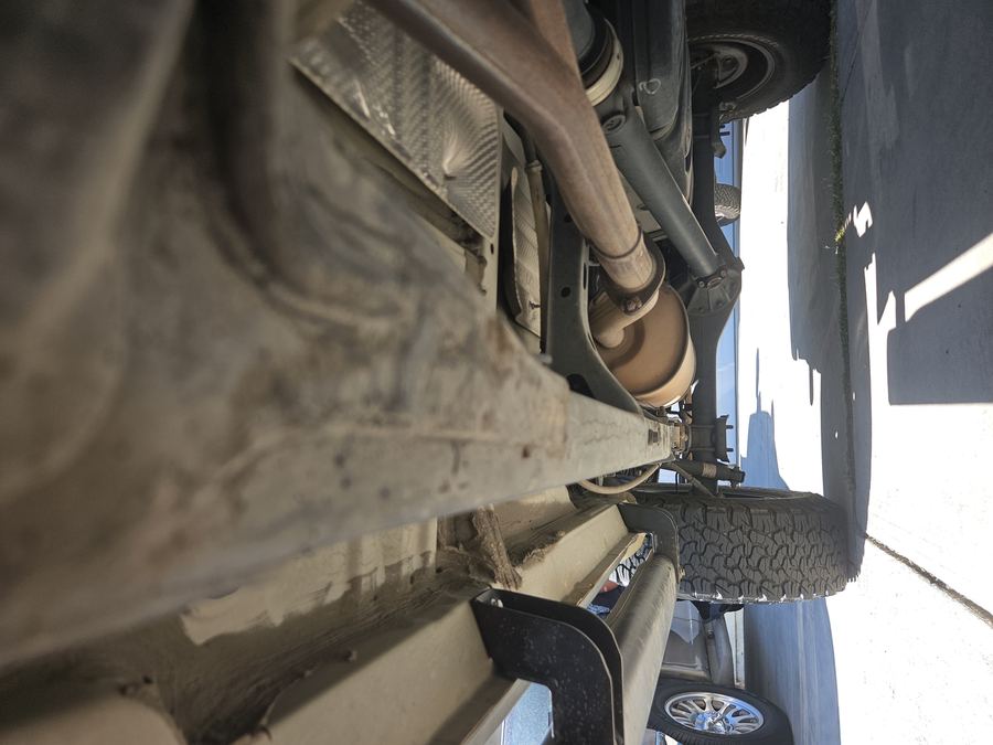 Underbody view of a pickup driveshaft and rear axle