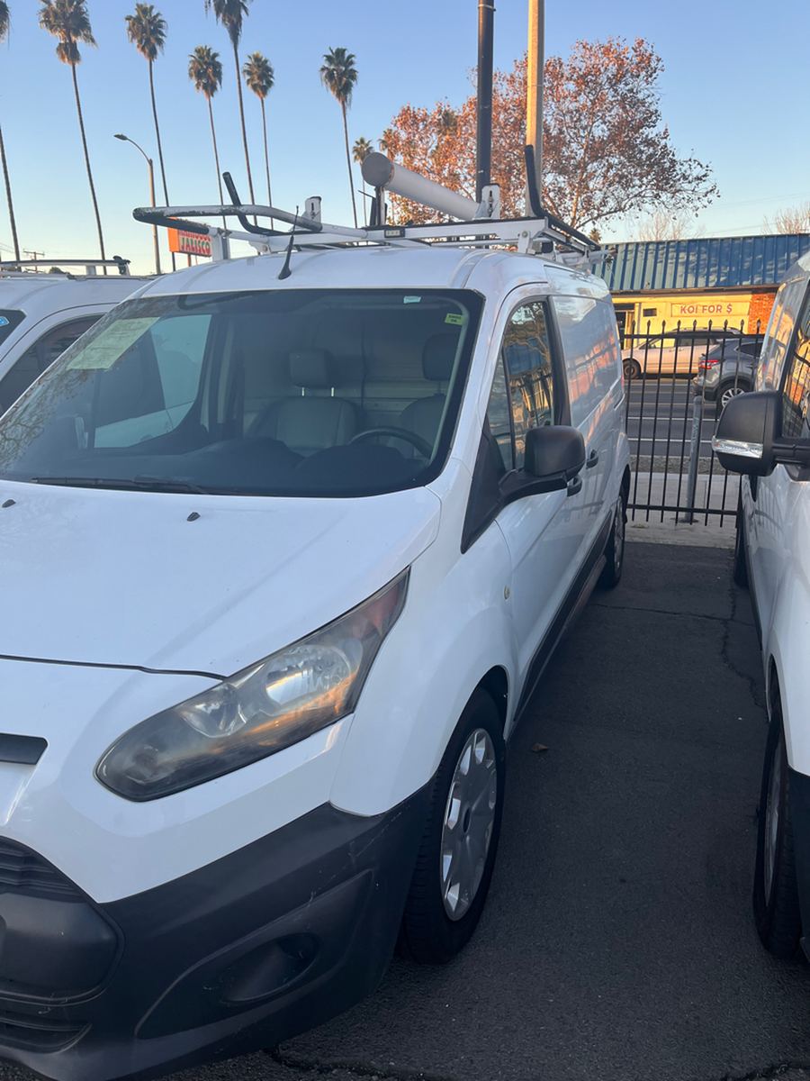 White Ford Transit Connect cargo van seen from the front corner on a dealer lot