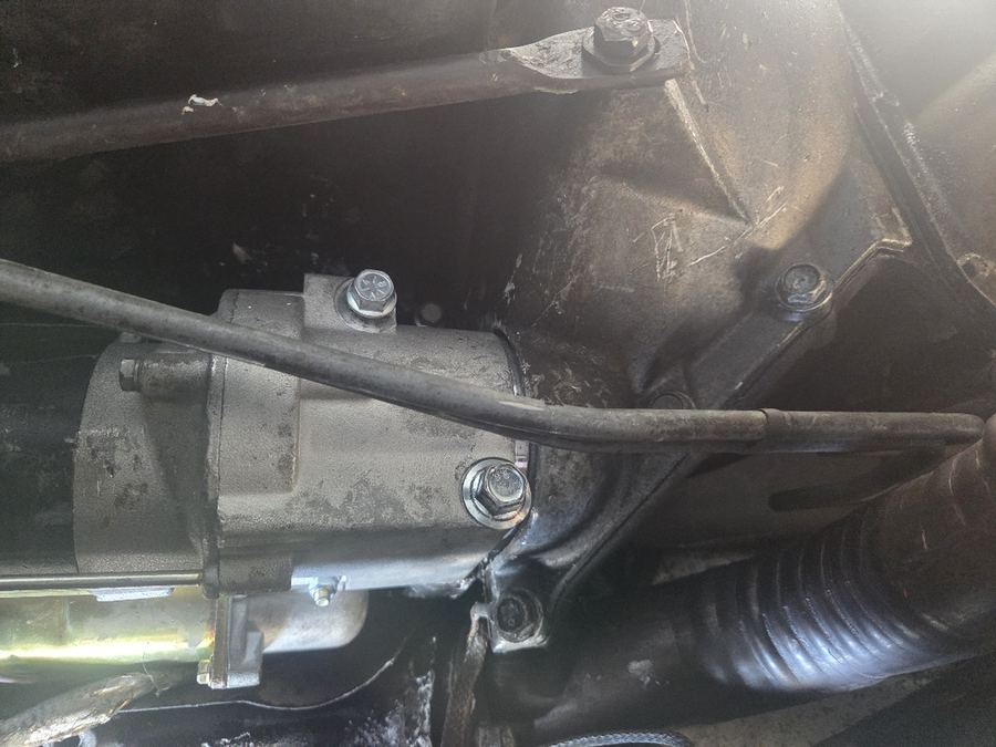 Close-up of a removed starter motor and its wiring