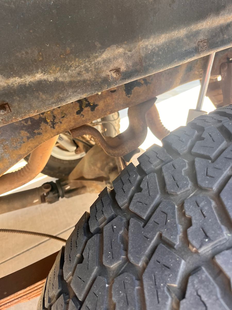 Rear leaf spring, shackle and tire photographed from below