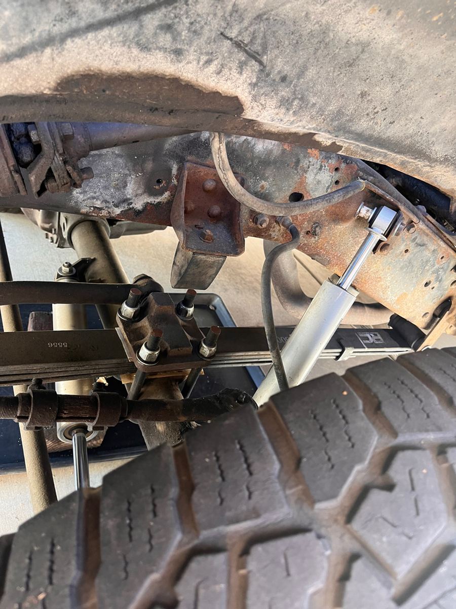 Front shock absorber and coil spring with the wheel removed