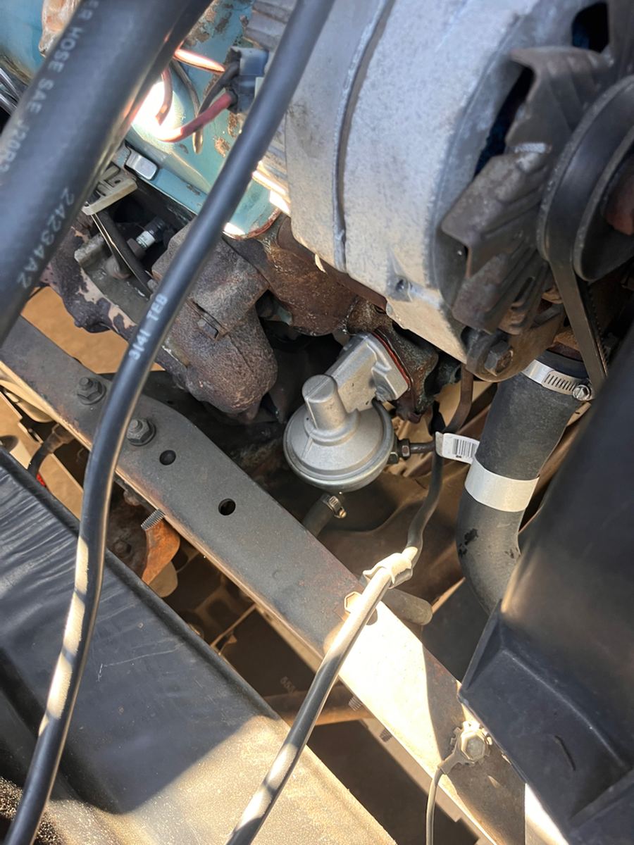 Lower ball joint and steering linkage seen from beneath a classic truck
