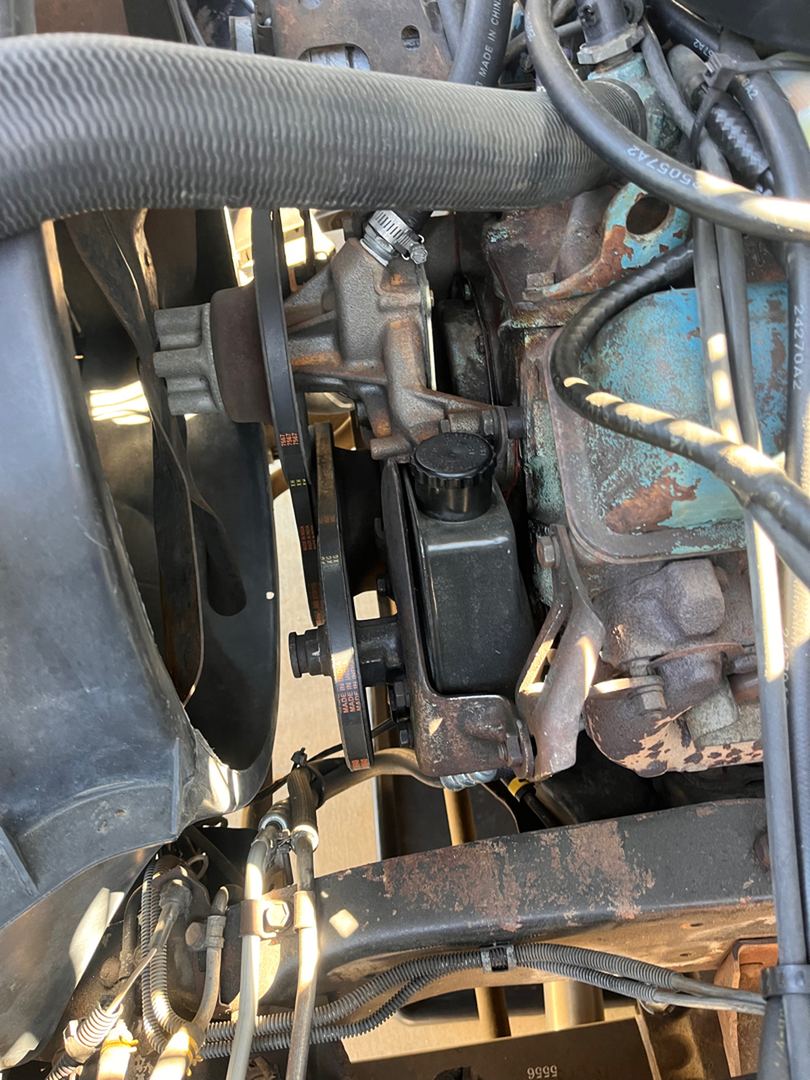 Power steering pump, belts and hoses on an old Chevy V8
