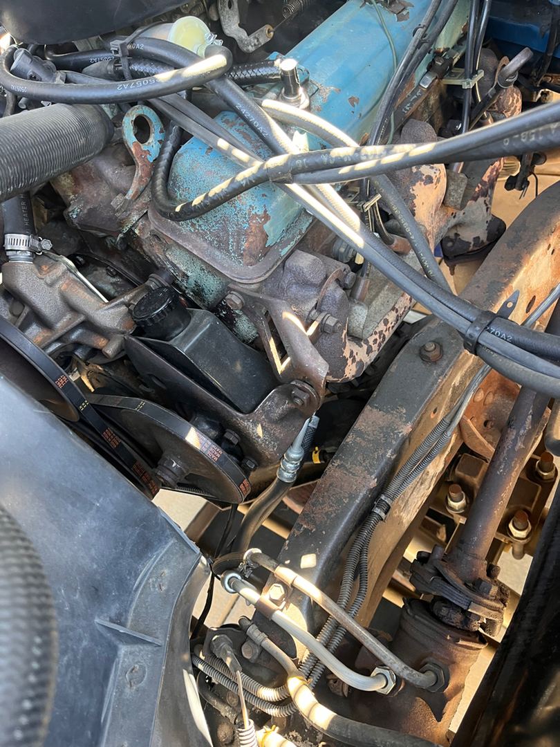 Engine bay of a 1979 Chevy truck, wiring and brake lines in view