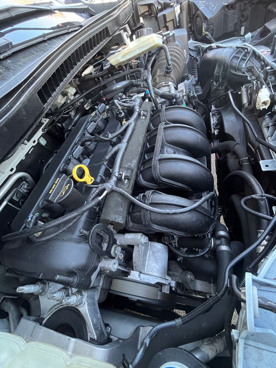 Engine bay of a small van with the hood open