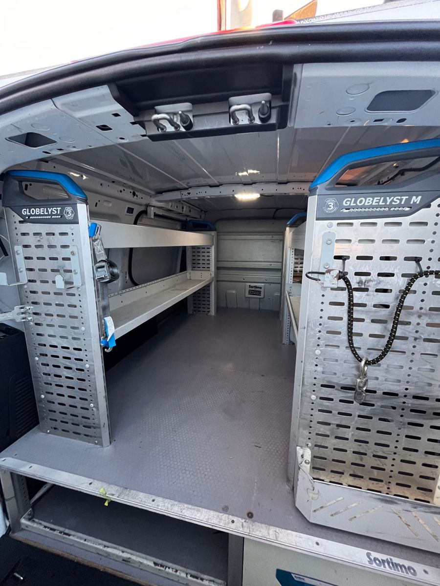 Cargo van load floor with shelving bolted through it