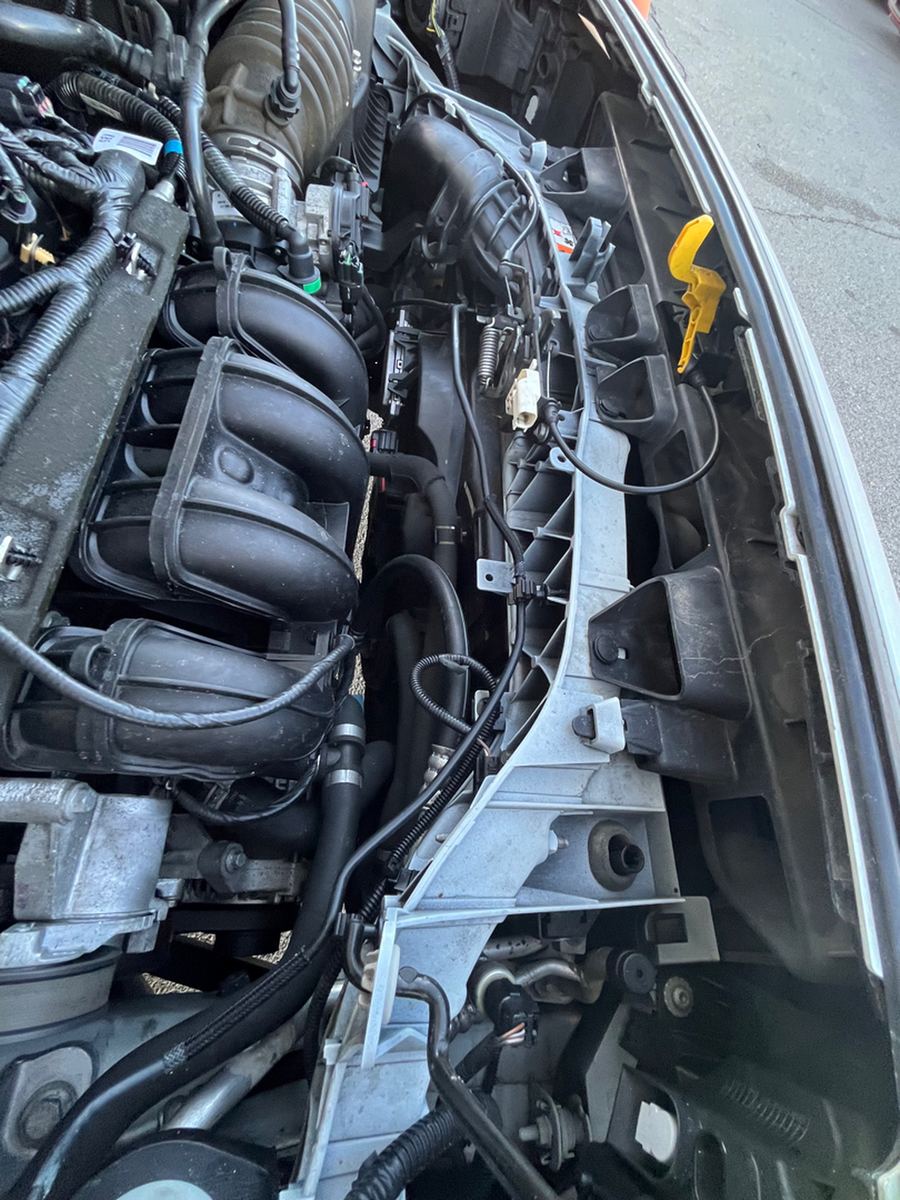 Engine bay of a small cargo van with the hood raised