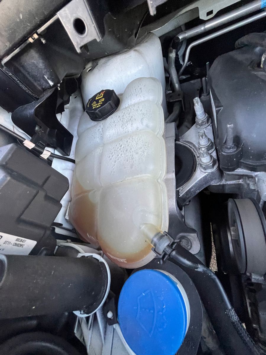 Coolant expansion tank and washer bottle in a van engine bay
