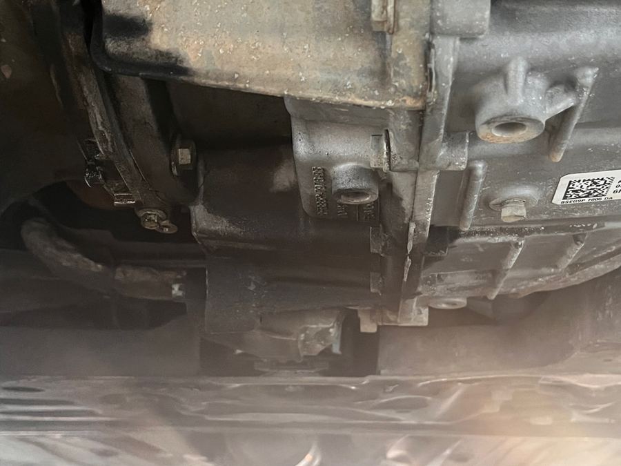 Transmission case and mount seen from underneath a small van