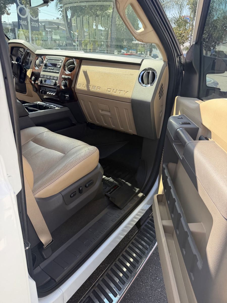 Front passenger seat, dash and running board of a Ford Super Duty seen through the open door