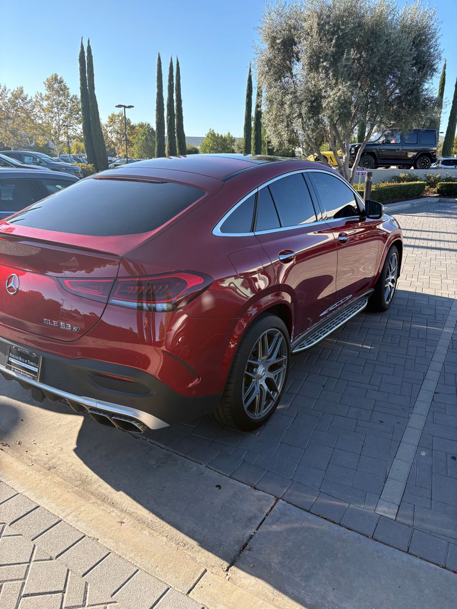 Side profile of a red AMG coupe showing the wheels and ride height