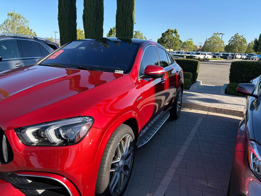 Front corner of a red Mercedes-AMG GLE coupe on a dealer lot