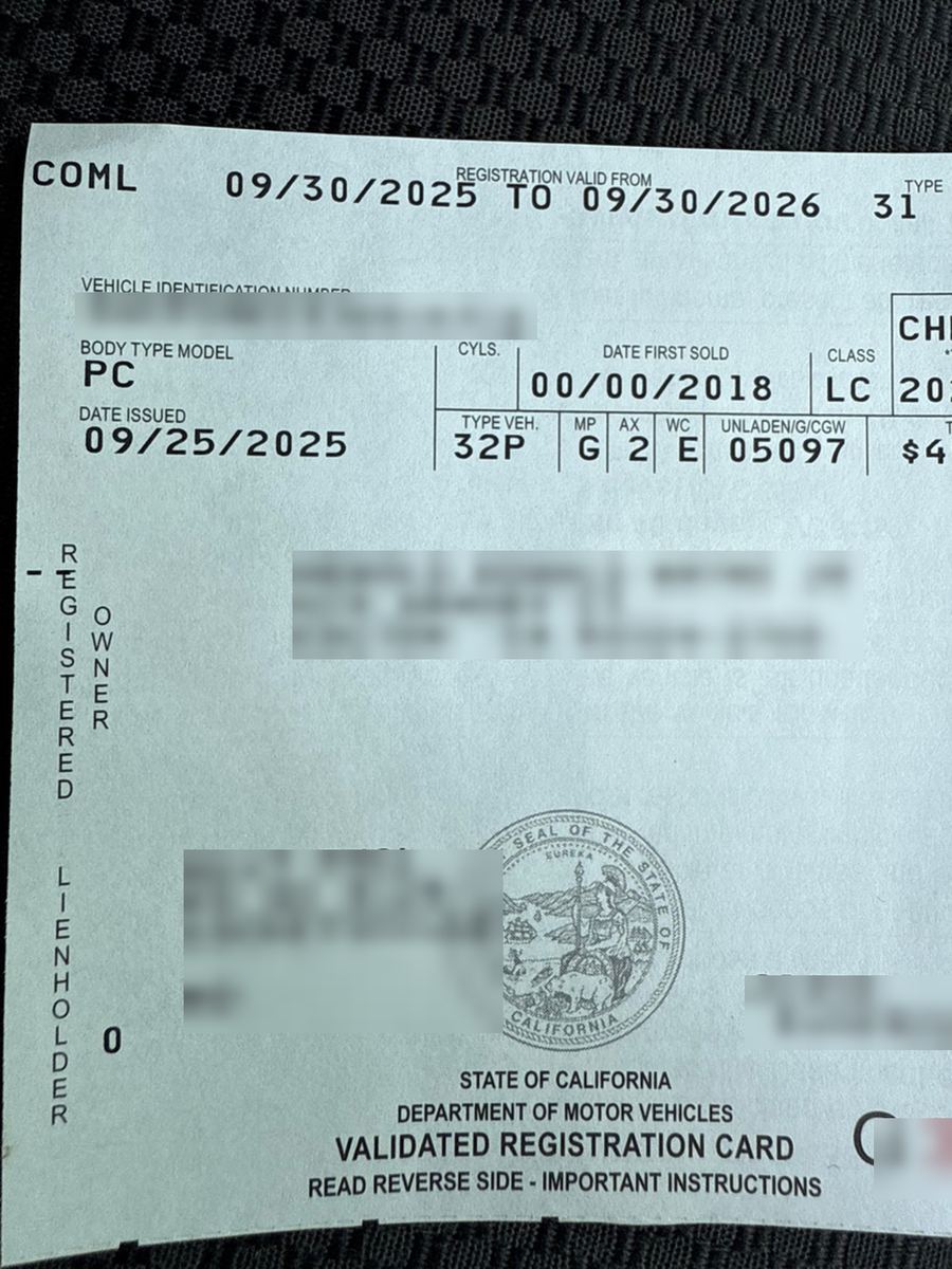 A California validated registration card with the owner name, address, VIN and lienholder blurred out