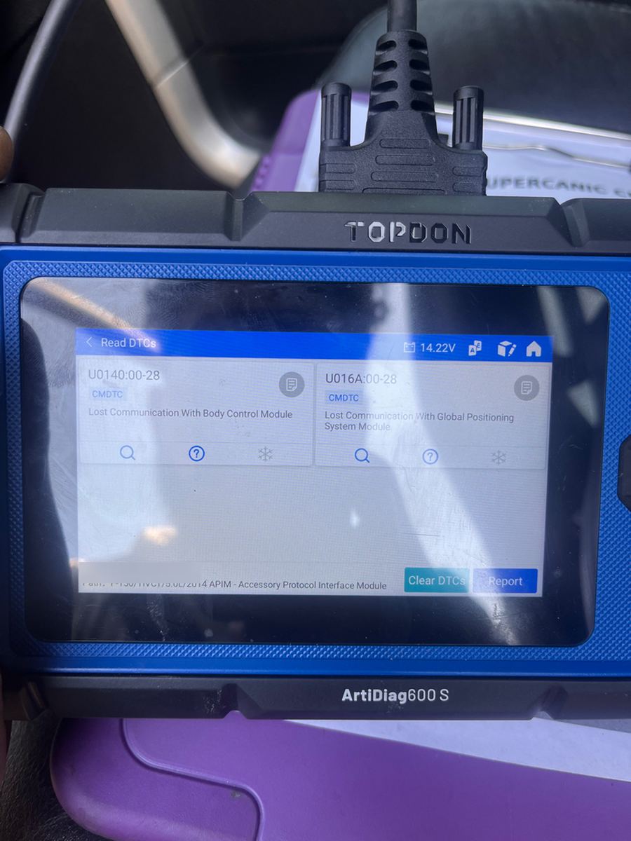 A TOPDON ArtiDiag600 S scan tool showing two stored communication fault codes, one for the body control module and one for the GPS module, VIN blurred out