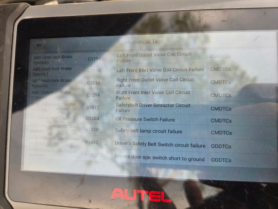 Autel scan tool screen listing ABS and seat belt trouble codes