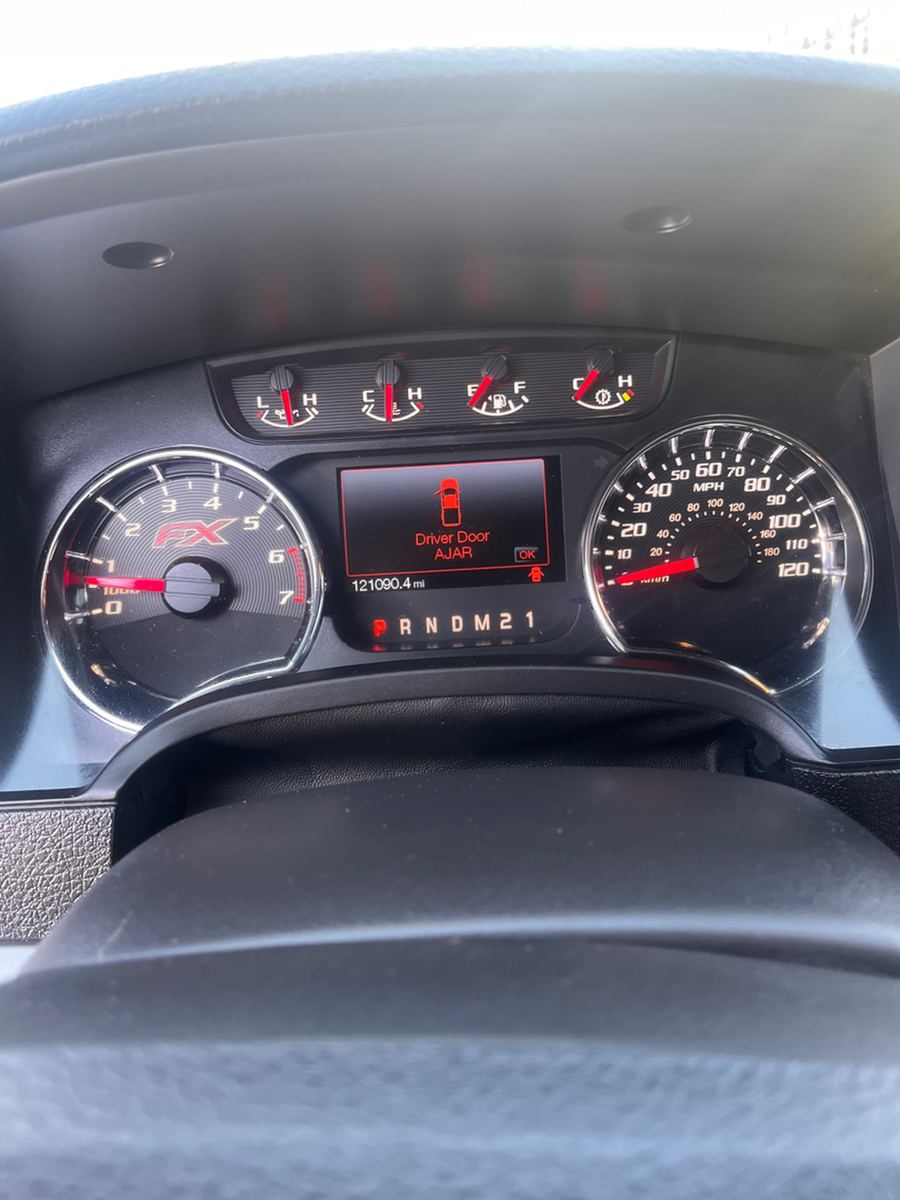 Lit instrument cluster showing the speedometer, tachometer and odometer