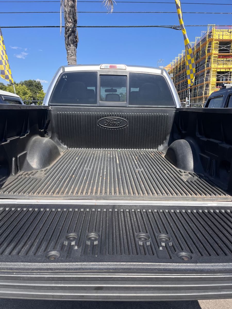 Empty pickup bed seen from behind the open tailgate