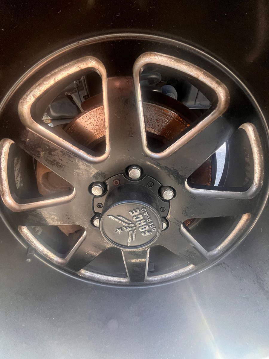 Alloy wheel removed from the hub, showing the brake rotor behind it