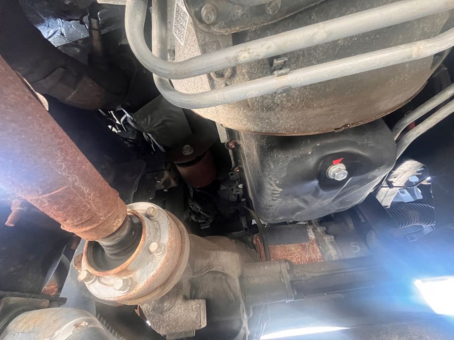Driveshaft and transfer case seen from beneath a four-wheel-drive pickup