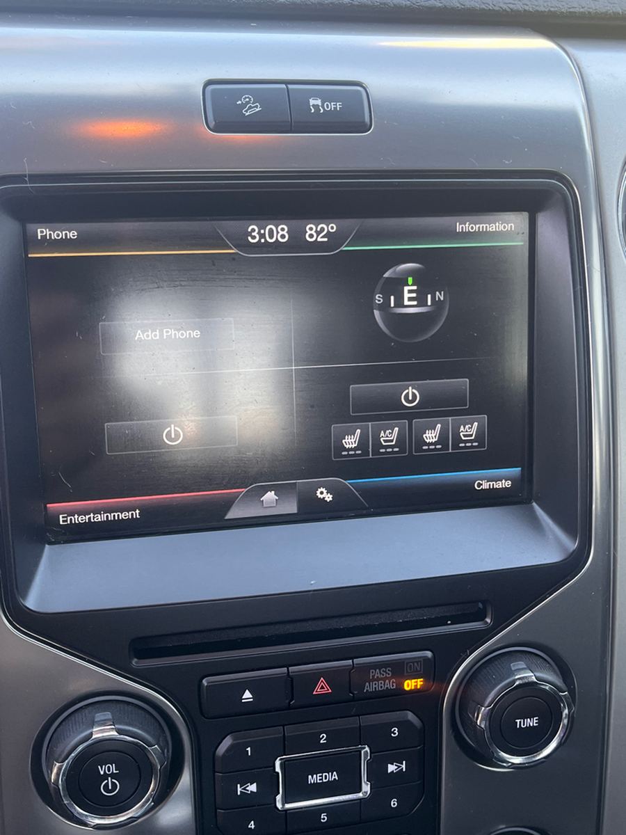 Touchscreen infotainment display and climate controls in a pickup dashboard