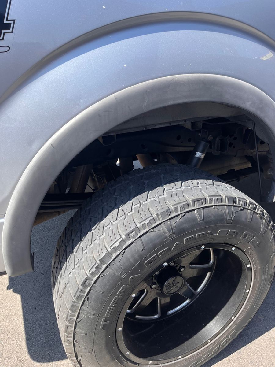 Fender lip and all-terrain tire on a lifted pickup