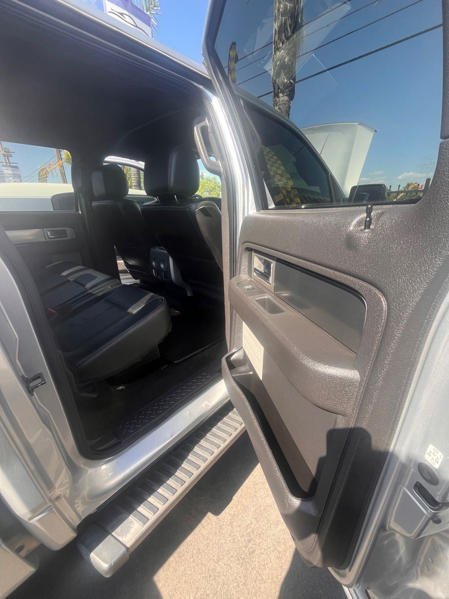 Rear door of a crew cab pickup standing open, showing the back seat