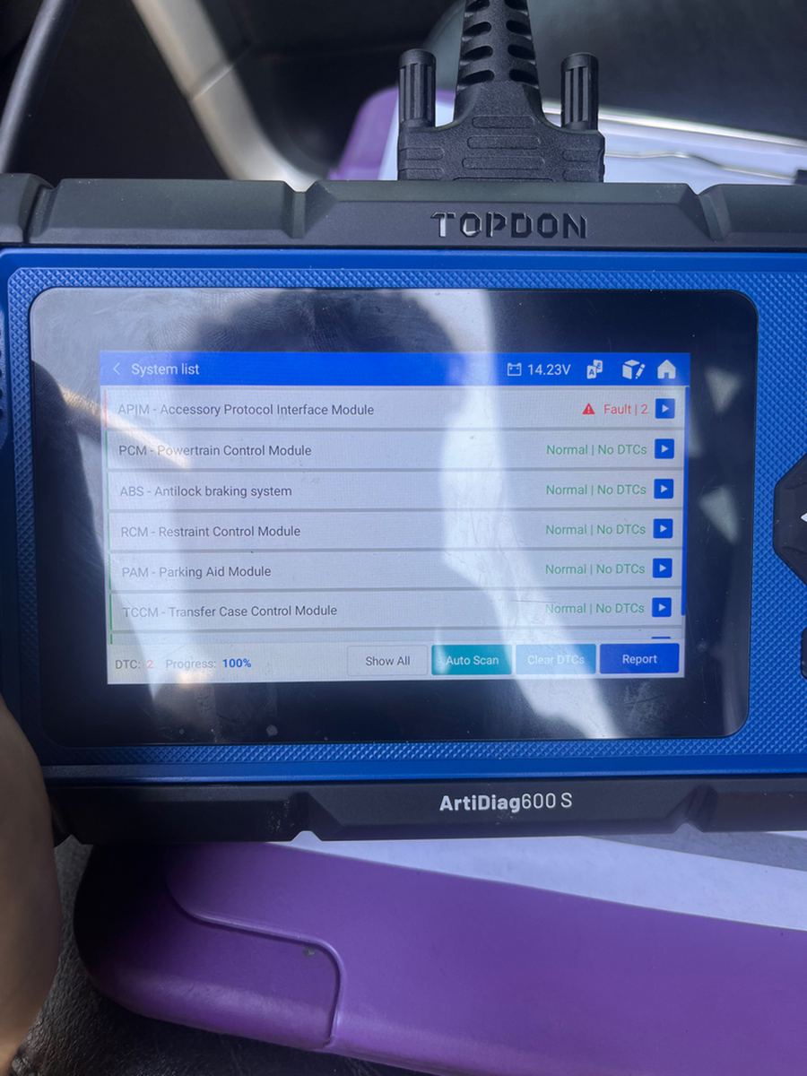 A TOPDON scan tool listing each module on a Ford F-150, one fault and the rest normal