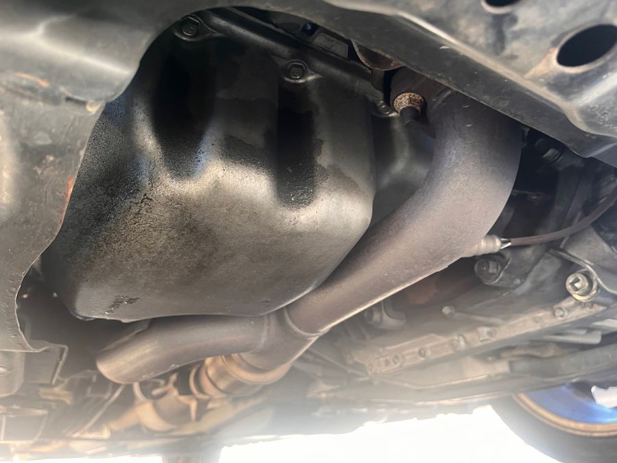 Exhaust pipe running beneath the floorpan, seen from underneath