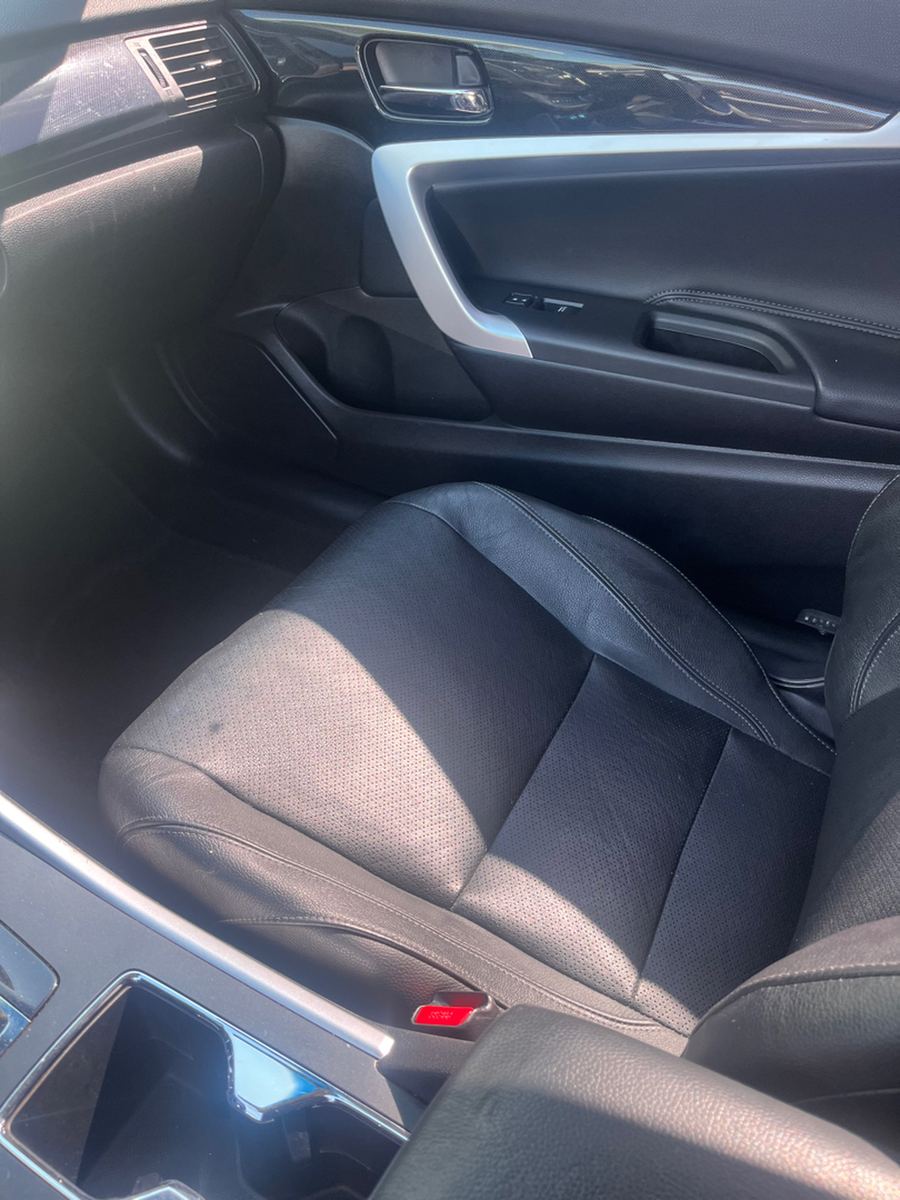 Front seats and belt webbing inside a Honda sedan