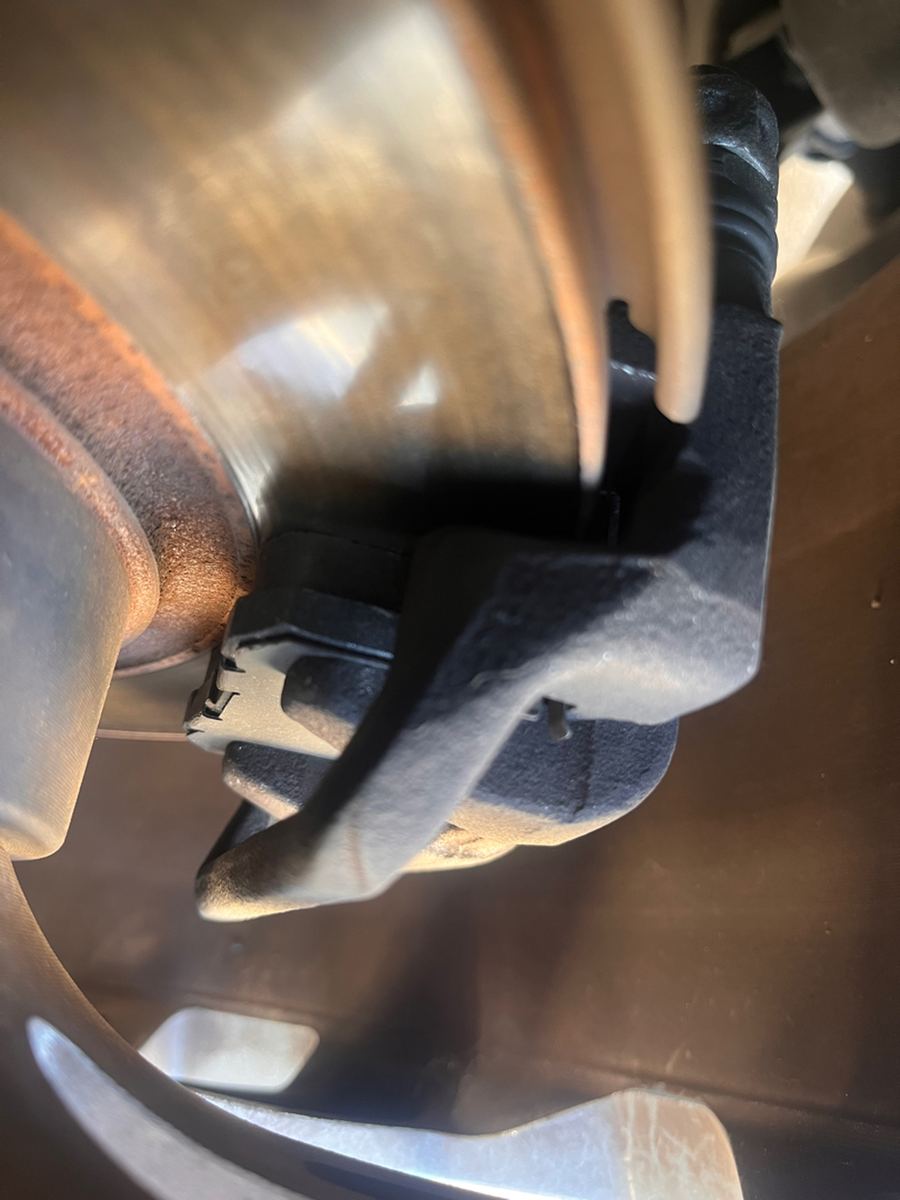 Exhaust heat shield seen from underneath a car