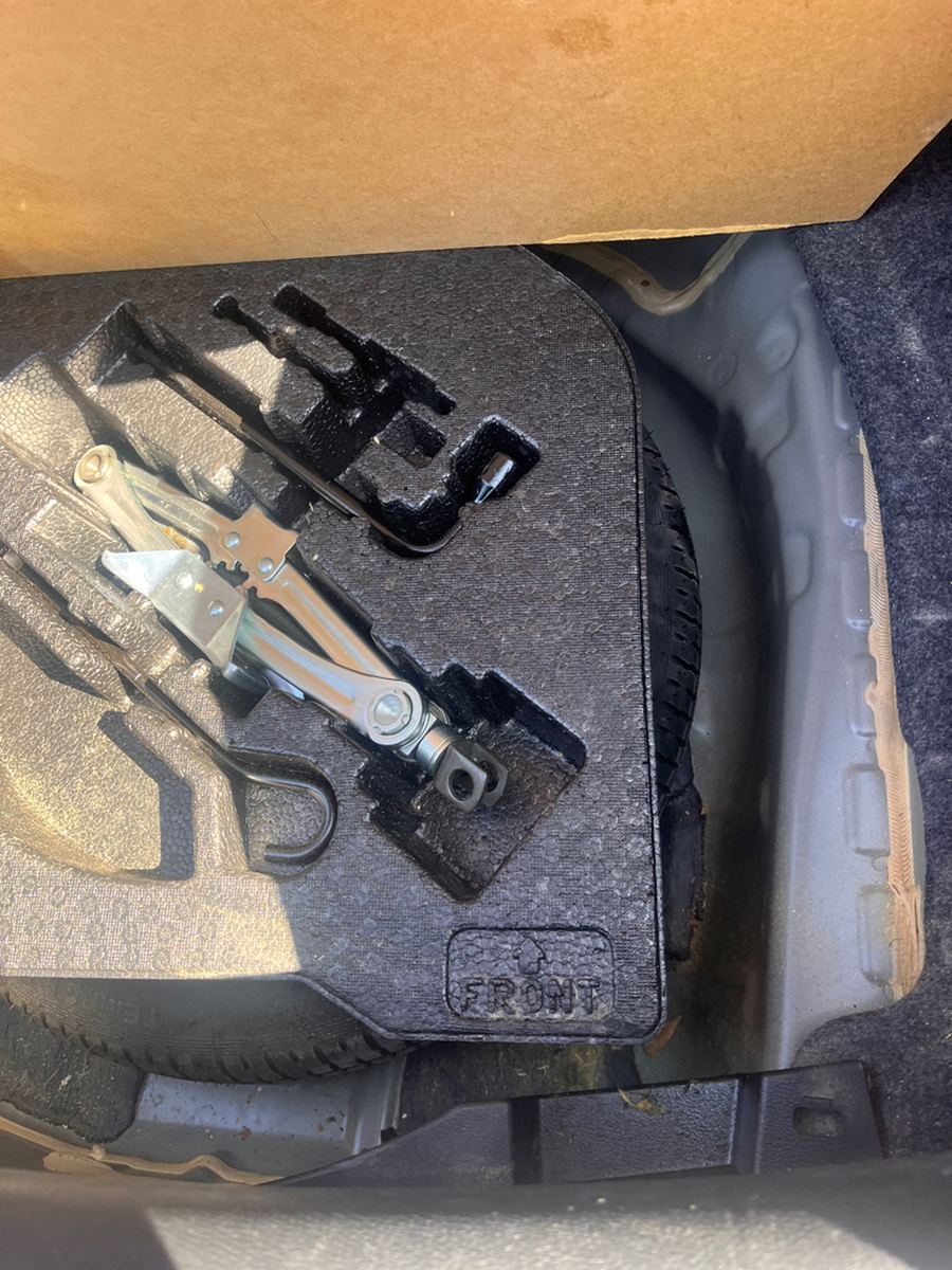 Driver footwell showing the pedals, carpet and floor mat