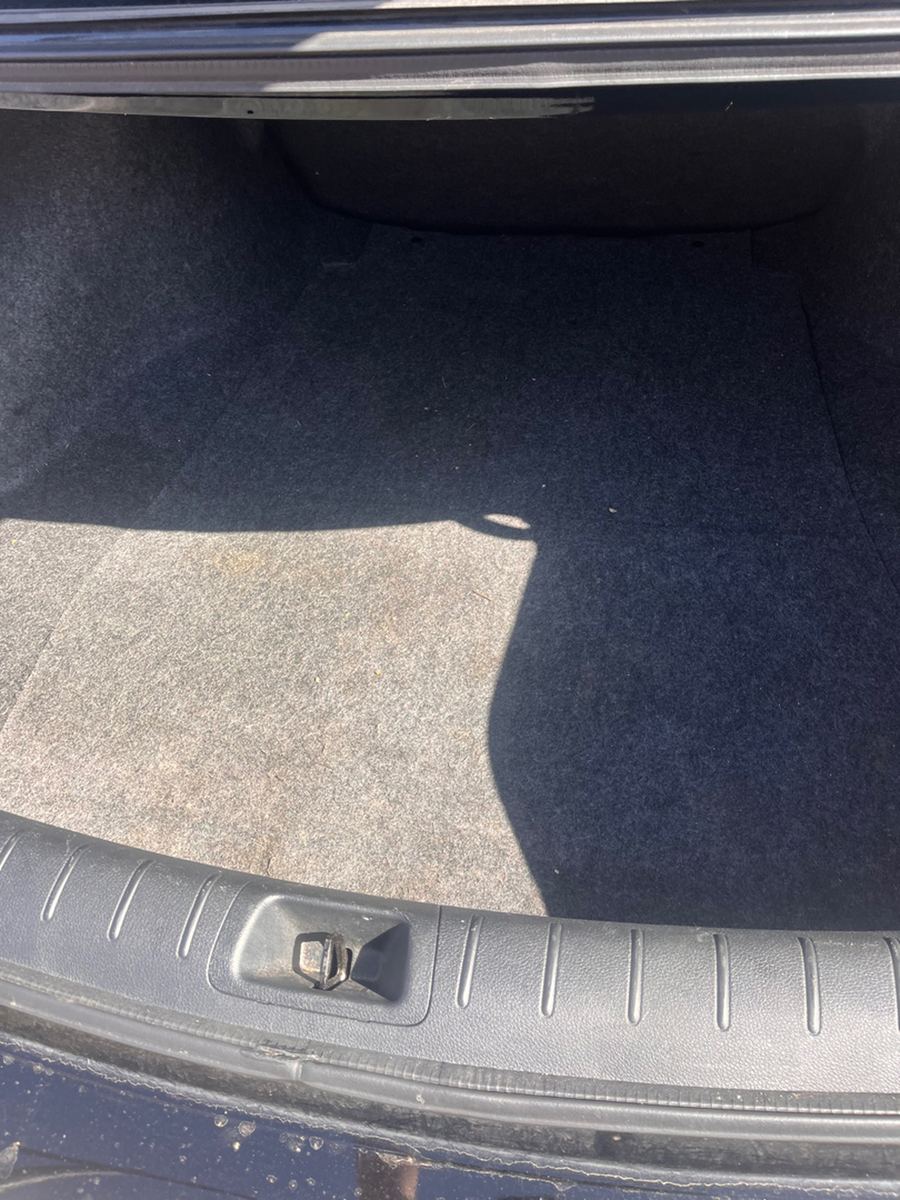 Open trunk floor with the spare wheel well exposed