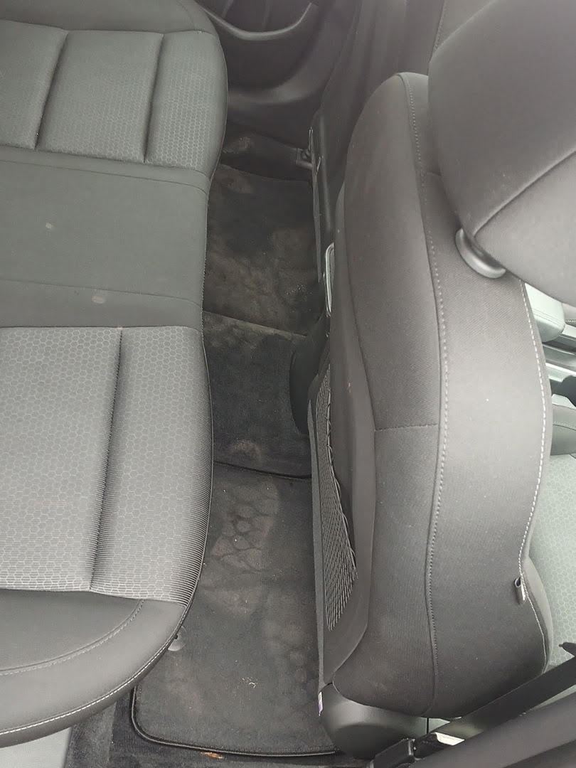 Rear seat and dirty floor mat inside a Hyundai