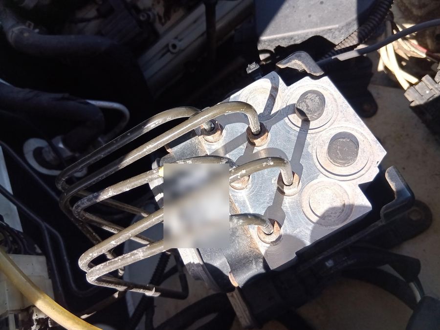 ABS pump and brake lines in an engine bay