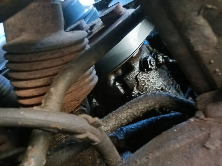 Steering rack boot and an oil soaked engine block seen from below