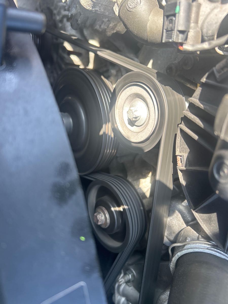 Serpentine belt and pulleys at the front of a Mercedes engine