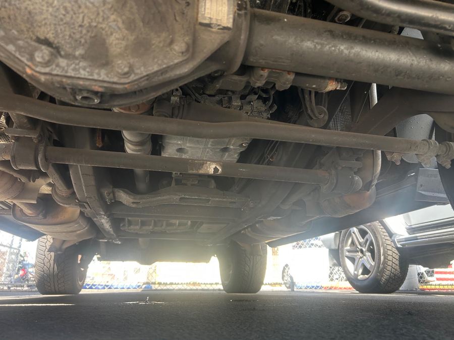 Underside of a G-Class from ground level, with axles, links and exhaust