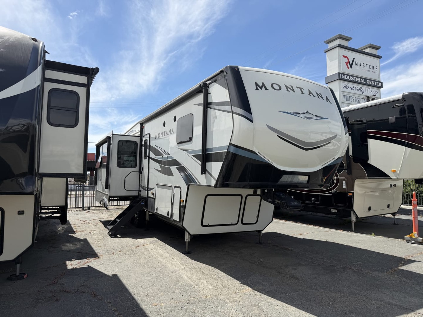 Keystone Montana fifth-wheel trailer on a dealer lot with its entry steps down