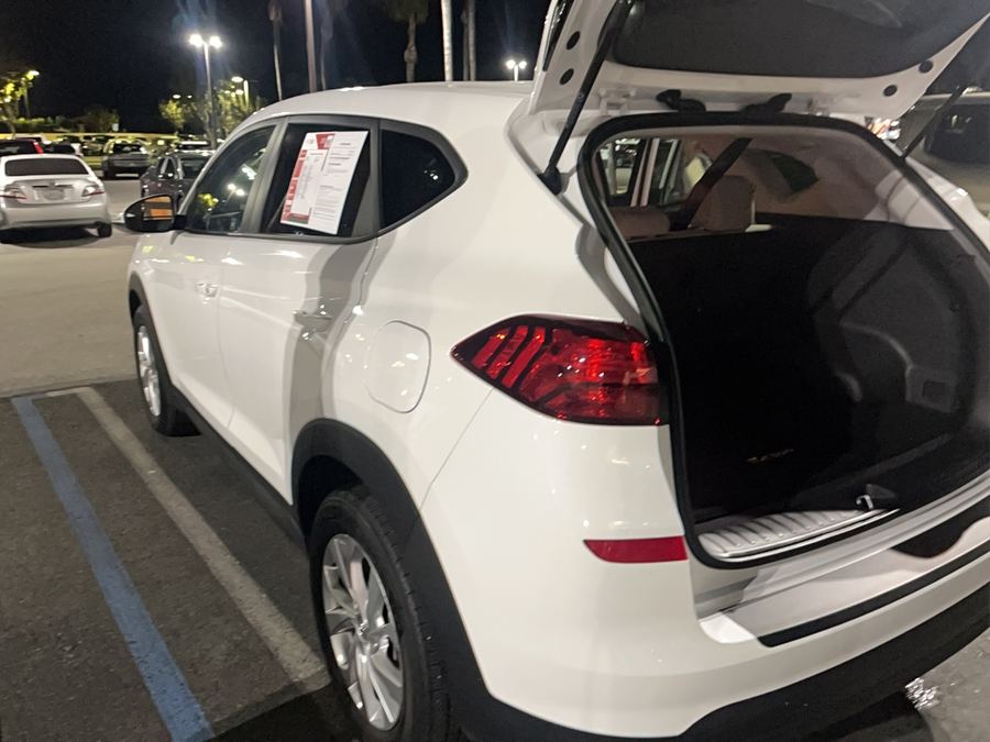 Open tailgate and load area of a white compact SUV