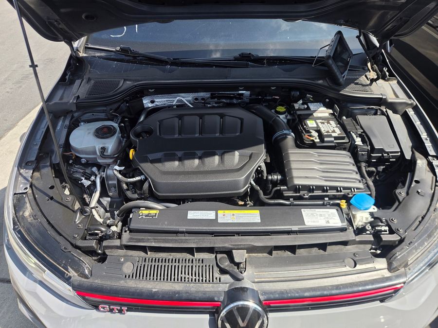 Engine bay of a Volkswagen GTI with the hood raised