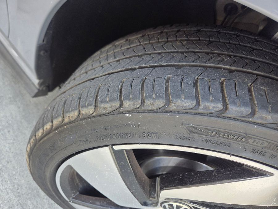 Front tire sidewall showing the size and load rating on an alloy wheel