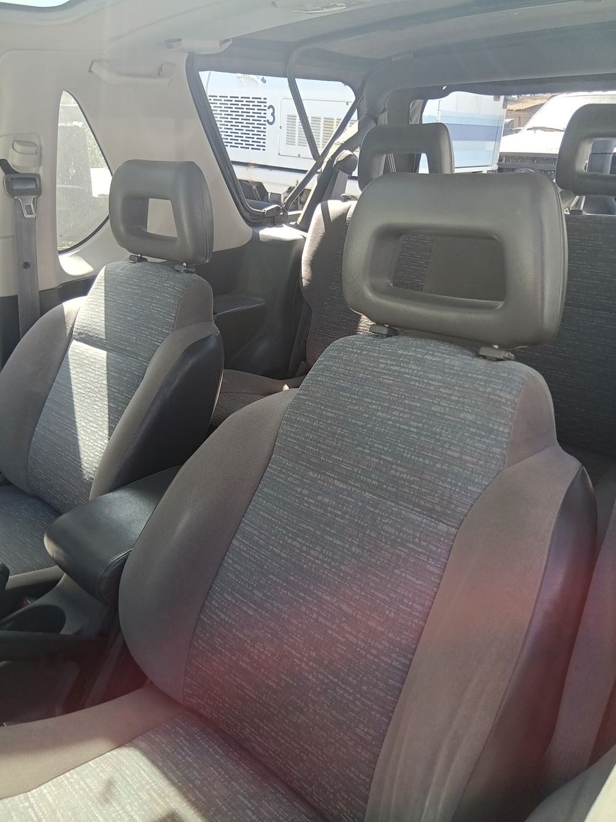 Cloth front seats inside an Isuzu Rodeo with the soft top open