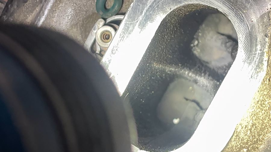 Timing cover removed from a Ford Explorer, exposing the internal water pump cavity