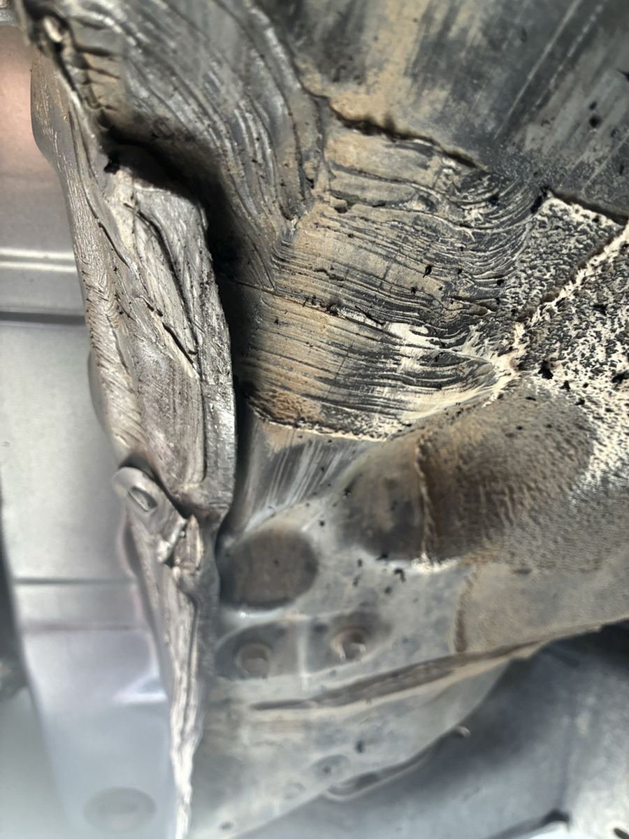 Flaking layered corrosion on a pickup cab mount