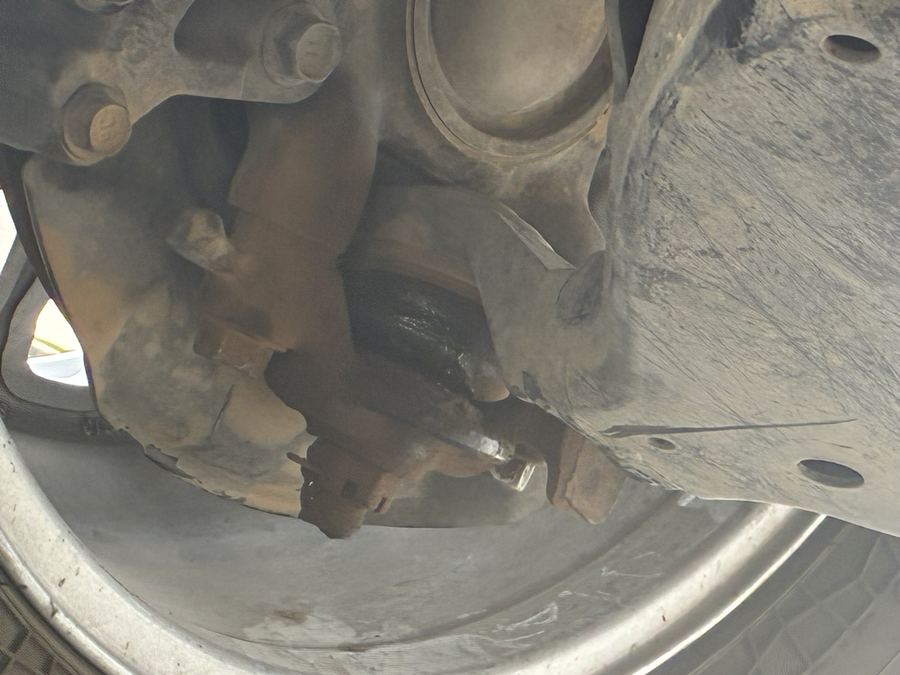 Rear differential and driveline seen from beneath a pickup