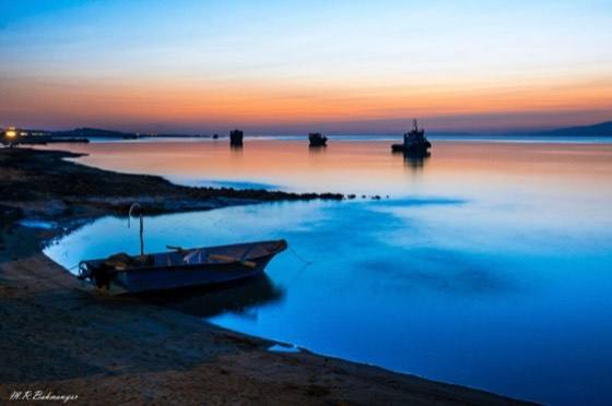 Small boat at the water's edge at dusk