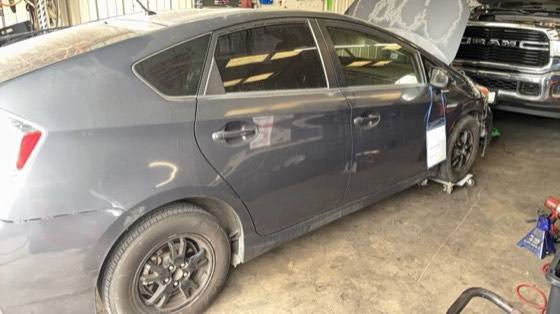 Grey Toyota Prius hybrid in the shop during an inspection