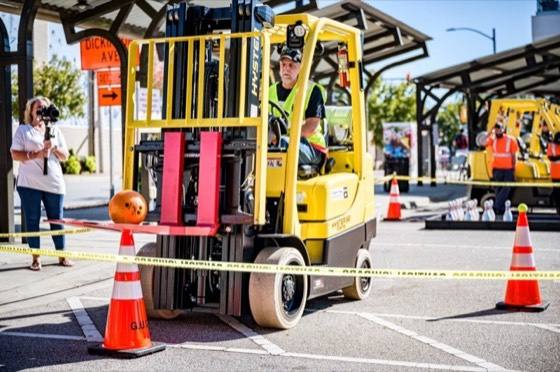 Yellow sit-down forklift on a paved lot